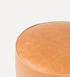 butterscotch-colored leather pouf