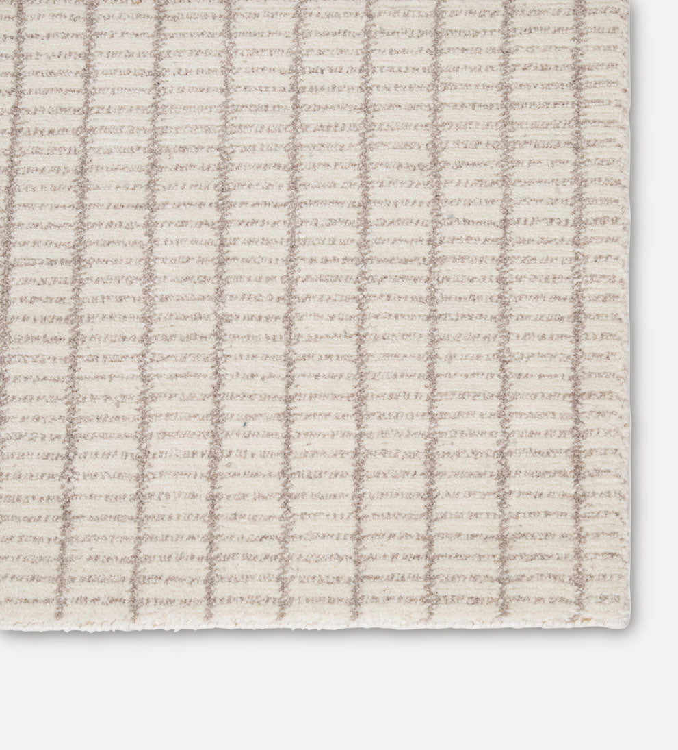 cream plaid-like pattern rug